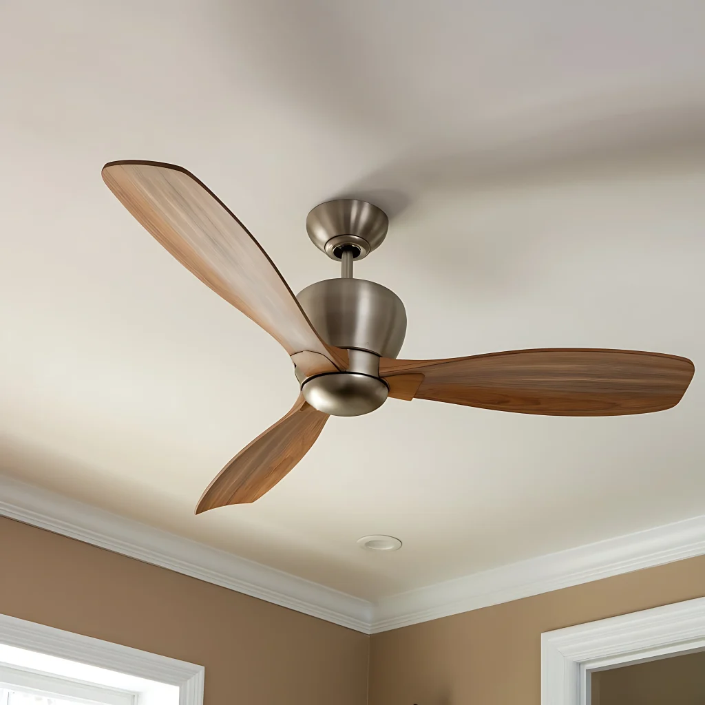 Ceiling fan with three wooden blades and brushed nickel finish mounted on a white ceiling in a Melbourne home