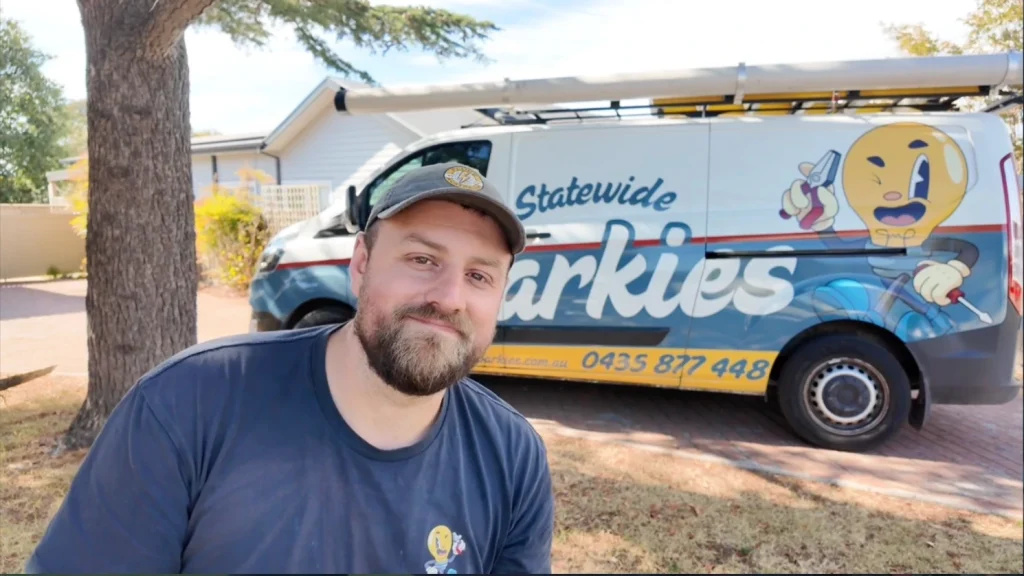 Statewide Sparkies electrician standing in front of a branded service van at a residential property in Australia
